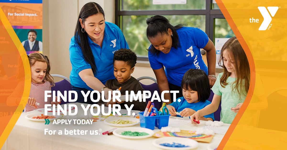 YMCA employees working with kids at an art table