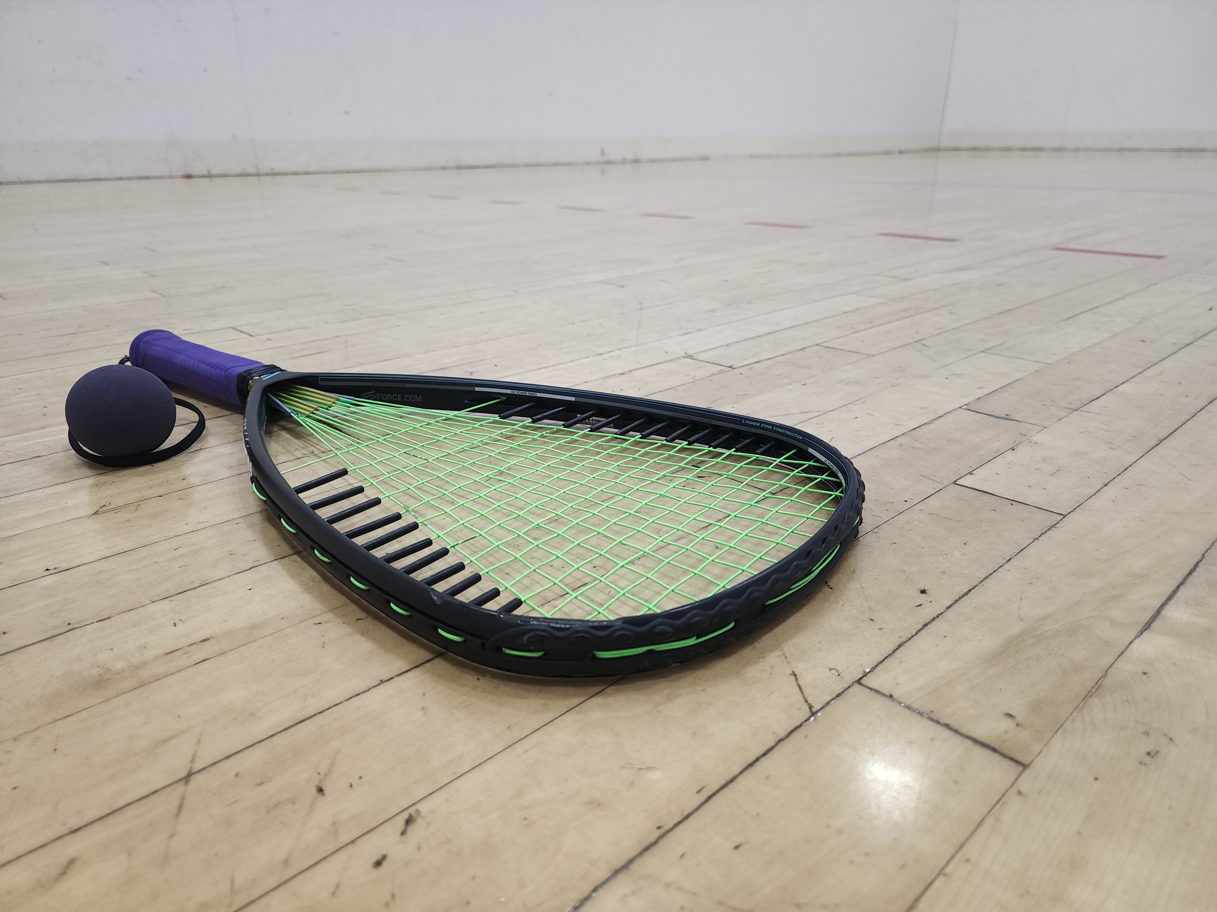 racquetball racquet on court floor