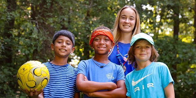 campers and a ymca counselor at day camp