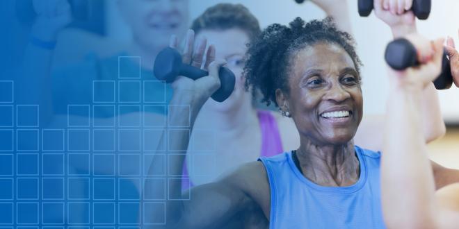 woman smiling and lifting weights