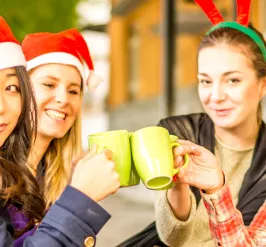 women with Santa hats and coffee mugs