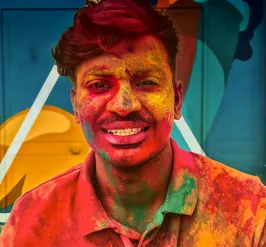 Shot of Holi color powder on man's face