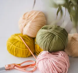 Multi-colored balls of yarn and scissors for crocheting 