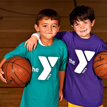 Two boys holding basketballs at YMCA