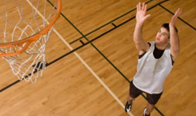 Boy shooting basketball