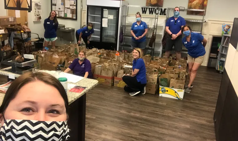 YMCA staff filing boxes with donated food