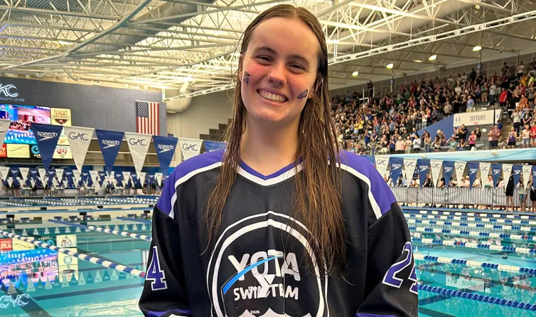 YOTA Swim Team Aubrey Mitchel holding Adolf Kiefer Youth Character Scholarship Award