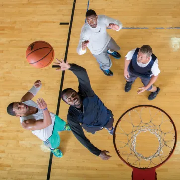 Men playing basketball at YMCA