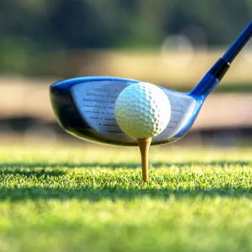 golf ball and putter at tee