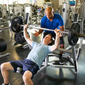 Man working out with personal trainer