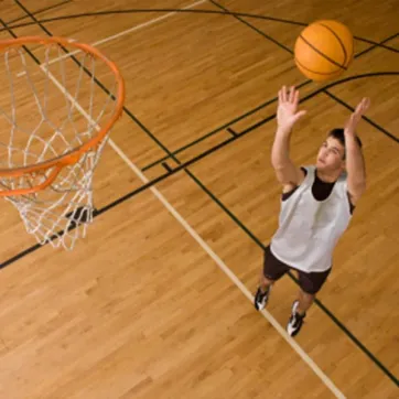 Boy shooting basketball