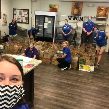 YMCA staff filing boxes with donated food