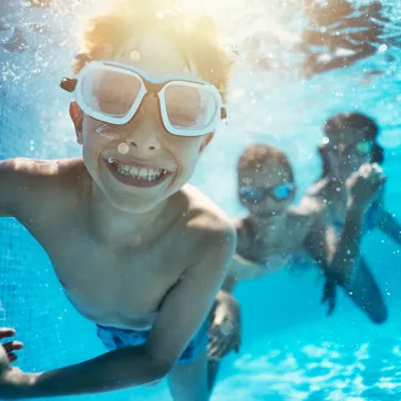 Boy smiling and swimming undewater