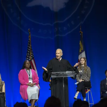 Judge speaking to students