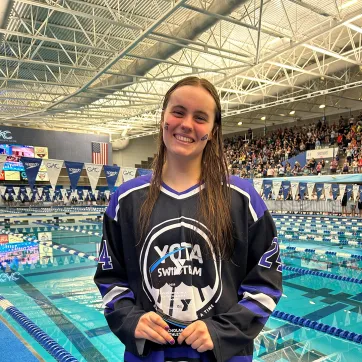YOTA Swim Team Aubrey Mitchel holding Adolf Kiefer Youth Character Scholarship Award