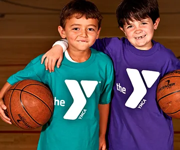 Two boys holding basketballs at YMCA
