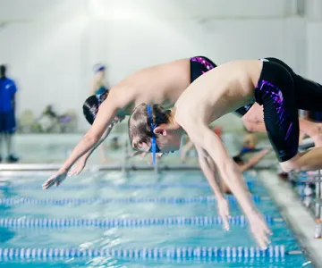Boys jumping into pool