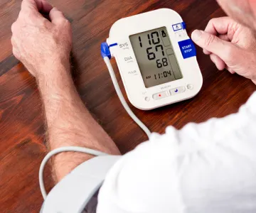 A man taking his own blood pressure