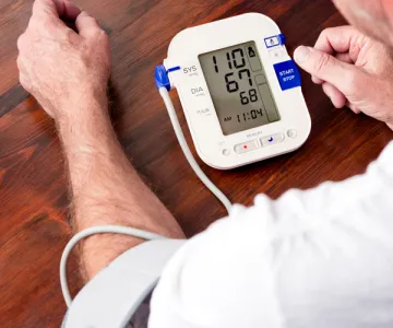 A man taking his own blood pressure