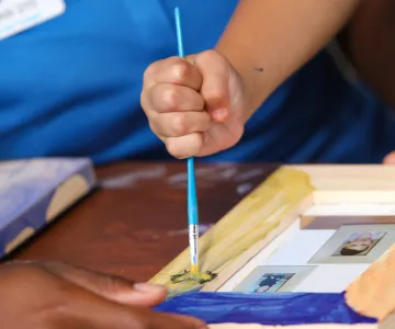 young child working on art project at summer camp